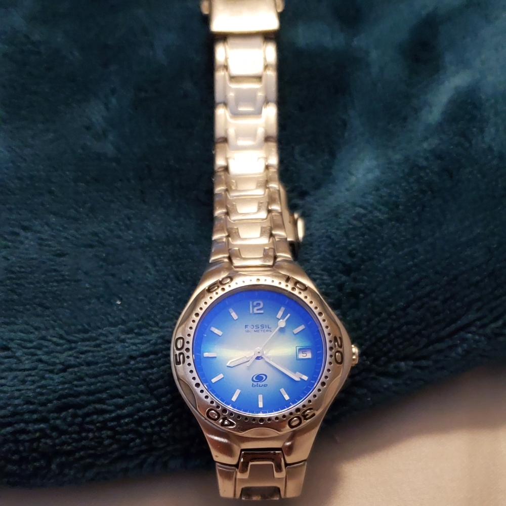 Women's blue fossil watch with silver band.